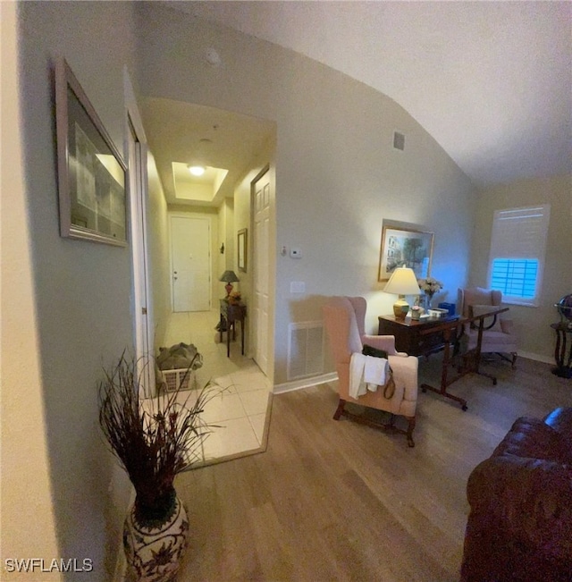 interior space featuring hardwood / wood-style floors and vaulted ceiling