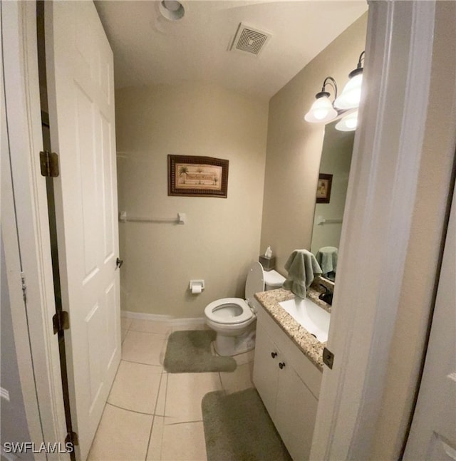 bathroom with tile patterned flooring, vanity, and toilet