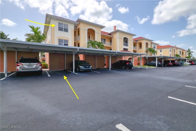 1105 Van Loon Commons Cir Unit 301, Cape Coral, FL 33909 - covered parking lot featuring a residential view