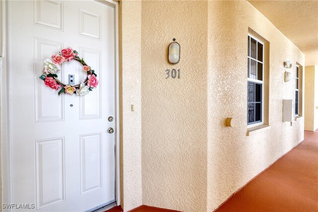 1105 Van Loon Commons Cir Unit 301, Cape Coral, FL 33909 - doorway to property featuring stucco siding
