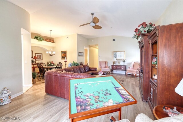 1105 Van Loon Commons Cir Unit 301, Cape Coral, FL 33909 - living area featuring a ceiling fan, light wood-type flooring, a chandelier, lofted ceiling, and arched walkways