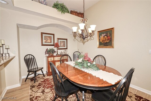 1105 Van Loon Commons Cir Unit 301, Cape Coral, FL 33909 - dining area with a chandelier, light wood-type flooring, and baseboards