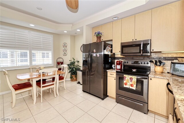 1105 Van Loon Commons Cir Unit 301, Cape Coral, FL 33909 - kitchen featuring stainless steel appliances, decorative backsplash, light stone counters, recessed lighting, and light tile patterned floors