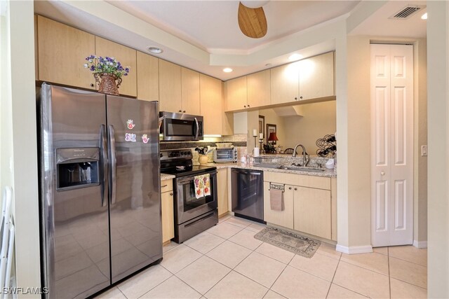 1105 Van Loon Commons Cir Unit 301, Cape Coral, FL 33909 - kitchen with appliances with stainless steel finishes, light tile patterned floors, light brown cabinetry, a sink, and recessed lighting