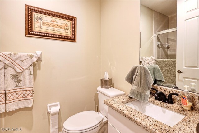 1105 Van Loon Commons Cir Unit 301, Cape Coral, FL 33909 - bathroom featuring vanity, toilet, and a shower stall