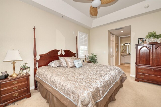 1105 Van Loon Commons Cir Unit 301, Cape Coral, FL 33909 - bedroom featuring light colored carpet, baseboards, ensuite bathroom, and a tray ceiling