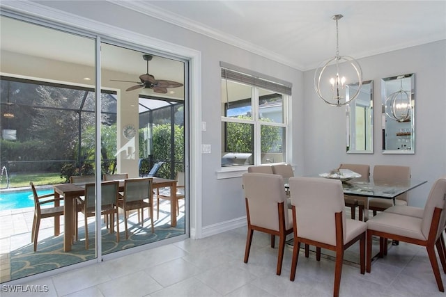 dining room featuring tile patterned flooring, ceiling fan with notable chandelier, baseboards, and ornamental molding