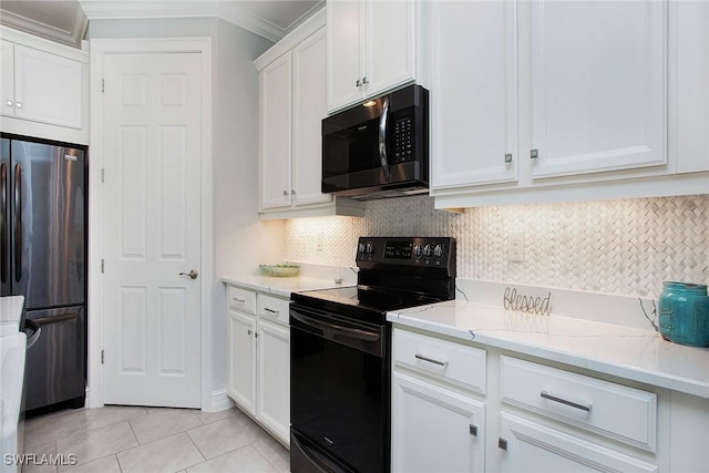 kitchen featuring crown molding, decorative backsplash, freestanding refrigerator, electric range, and white cabinetry