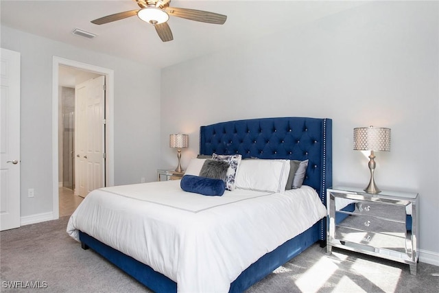 carpeted bedroom with visible vents, a ceiling fan, and baseboards