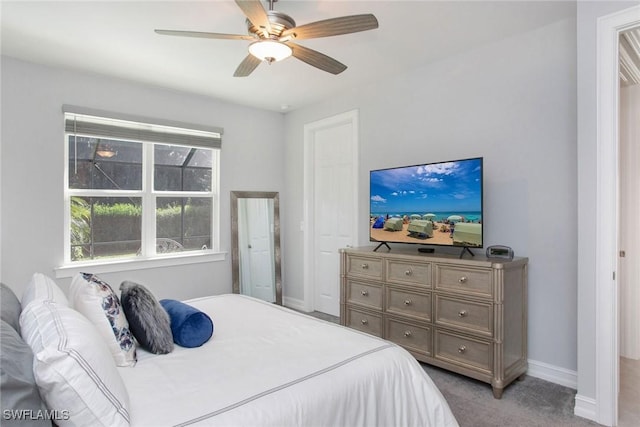 bedroom with a ceiling fan, baseboards, and light carpet