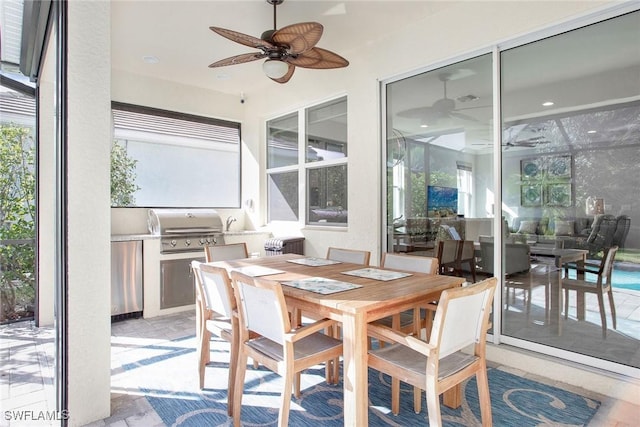 sunroom featuring a healthy amount of sunlight and a ceiling fan