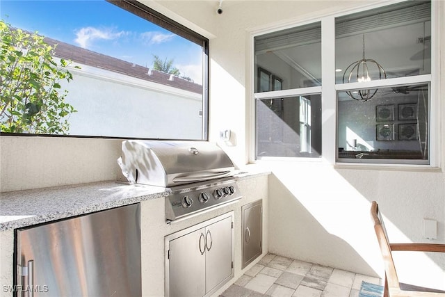 view of patio featuring a grill and an outdoor kitchen