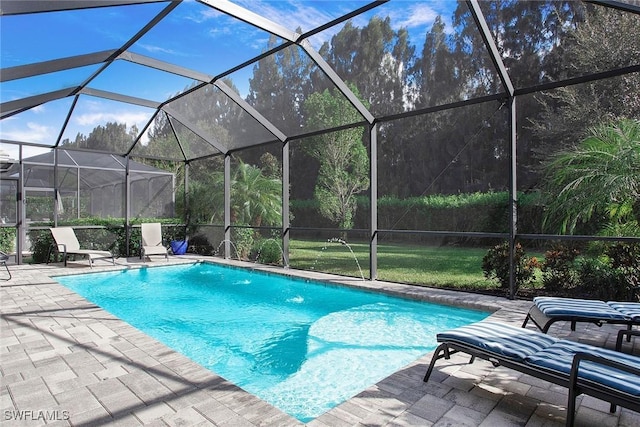 pool with glass enclosure and a patio