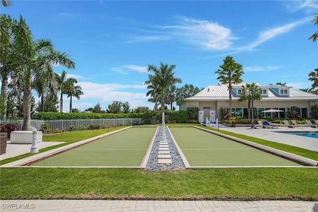 surrounding community with a lawn and fence