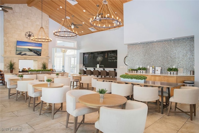 dining space featuring a notable chandelier, wood ceiling, and high vaulted ceiling