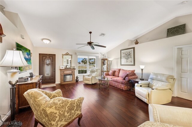 living room with dark hardwood / wood-style flooring, ceiling fan, and lofted ceiling