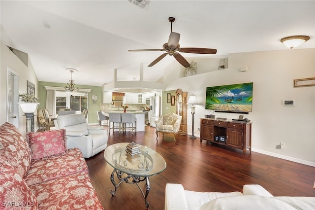 living room with dark hardwood / wood-style flooring, ceiling fan with notable chandelier, and lofted ceiling