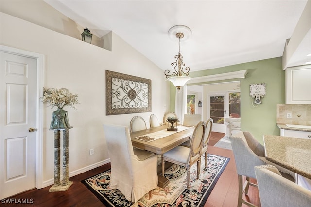 dining area featuring hardwood / wood-style floors and vaulted ceiling