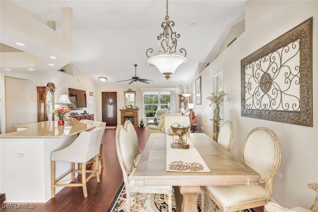 dining area with wood-type flooring, vaulted ceiling, and ceiling fan