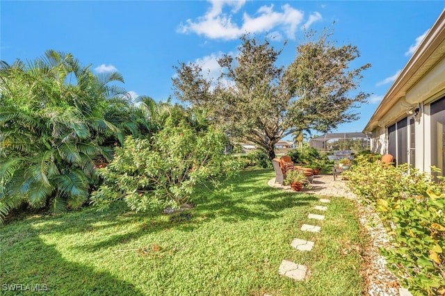 view of yard featuring glass enclosure