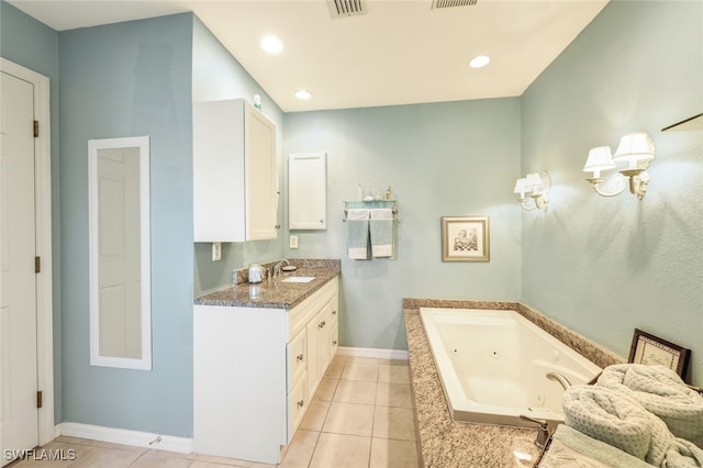 bathroom featuring tiled tub, tile patterned flooring, and vanity