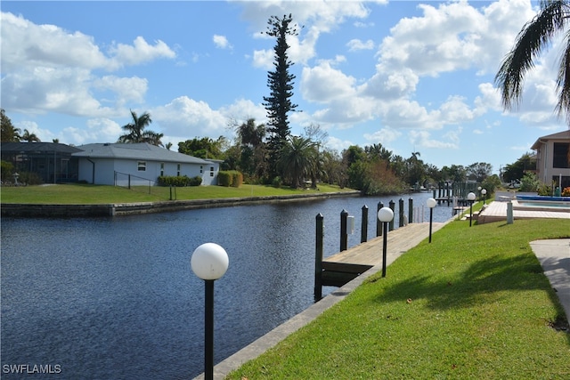 view of dock featuring a yard and a water view