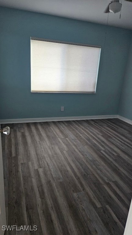 spare room with dark hardwood / wood-style floors