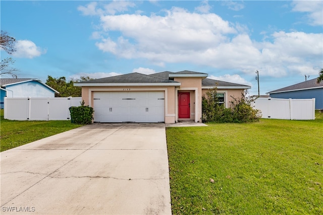 view of front of house with a garage and a front lawn