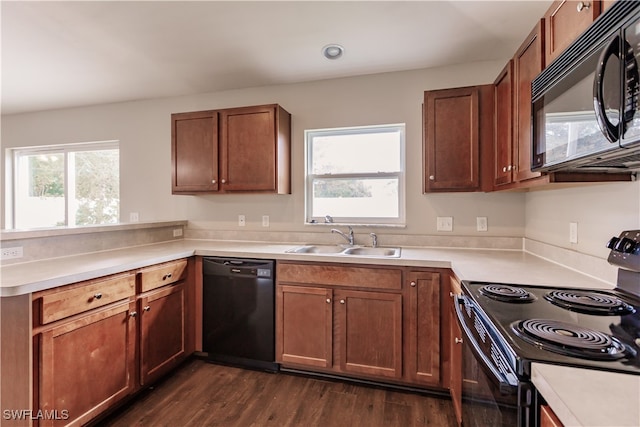 kitchen featuring dark hardwood / wood-style floors, black appliances, and sink