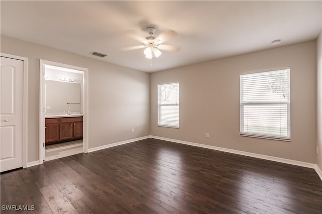 spare room with ceiling fan and dark hardwood / wood-style flooring