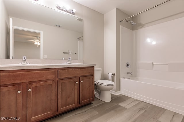 full bathroom featuring shower / bathing tub combination, hardwood / wood-style floors, ceiling fan, toilet, and vanity