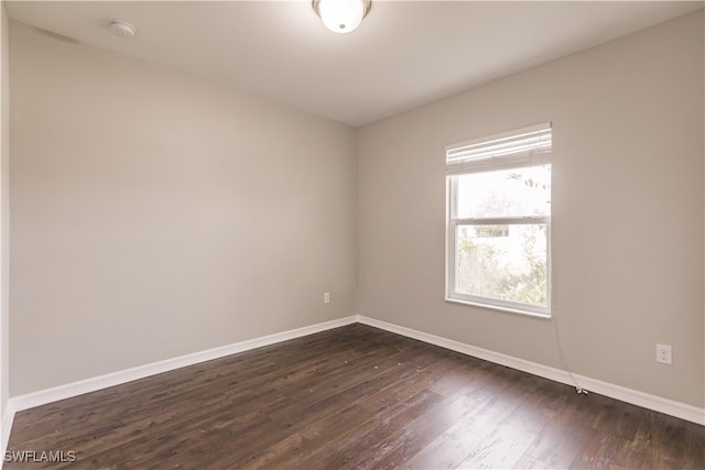 empty room featuring dark hardwood / wood-style flooring