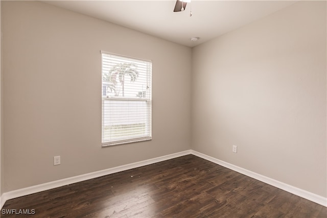 spare room with a wealth of natural light, ceiling fan, and dark hardwood / wood-style flooring