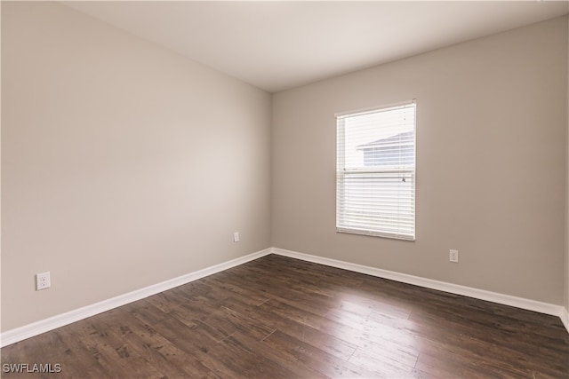 spare room featuring dark hardwood / wood-style floors