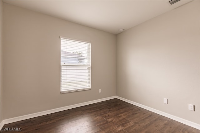 empty room with dark hardwood / wood-style floors