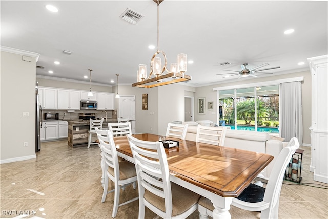 dining room with ornamental molding and ceiling fan