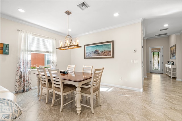 dining room with a wealth of natural light, ornamental molding, and an inviting chandelier