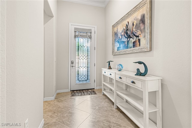 tiled foyer featuring ornamental molding