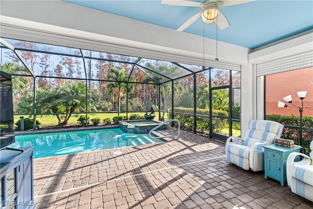 view of swimming pool with an in ground hot tub, a patio, glass enclosure, and ceiling fan