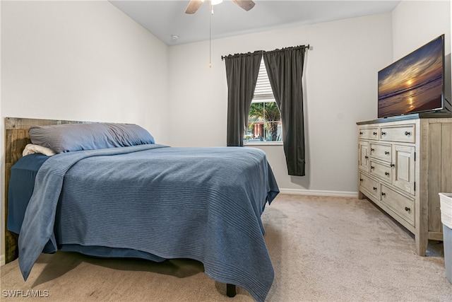 carpeted bedroom with ceiling fan and vaulted ceiling