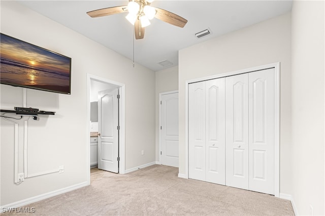 unfurnished bedroom with light carpet, a closet, and ceiling fan