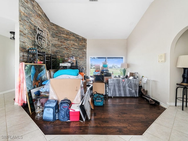 living room with tile patterned floors and vaulted ceiling