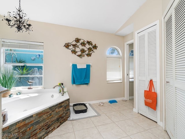 bathroom with tile patterned flooring and tiled tub