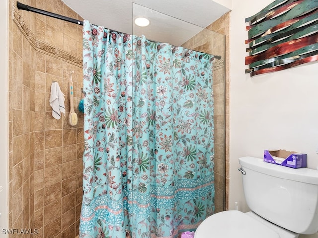 bathroom with toilet and walk in shower