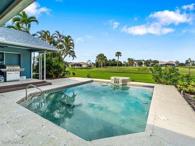 view of pool featuring area for grilling, a patio area, and a lawn