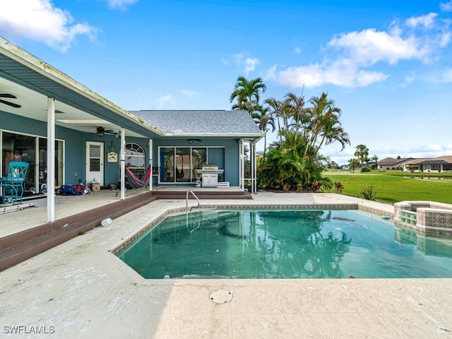 view of pool with a patio, ceiling fan, area for grilling, and a jacuzzi