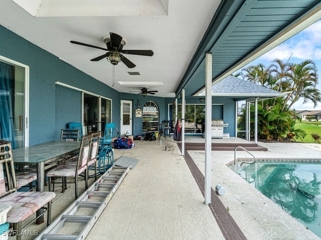 view of swimming pool with a patio and ceiling fan