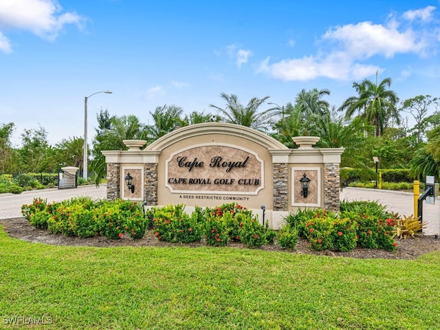 community sign featuring a lawn