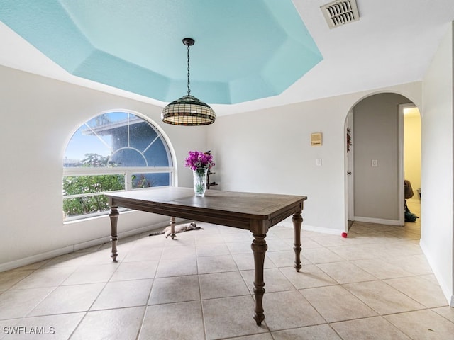 office with light tile patterned flooring and a raised ceiling