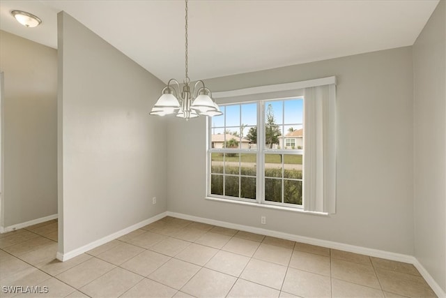 unfurnished dining area with vaulted ceiling, light tile patterned floors, and a chandelier